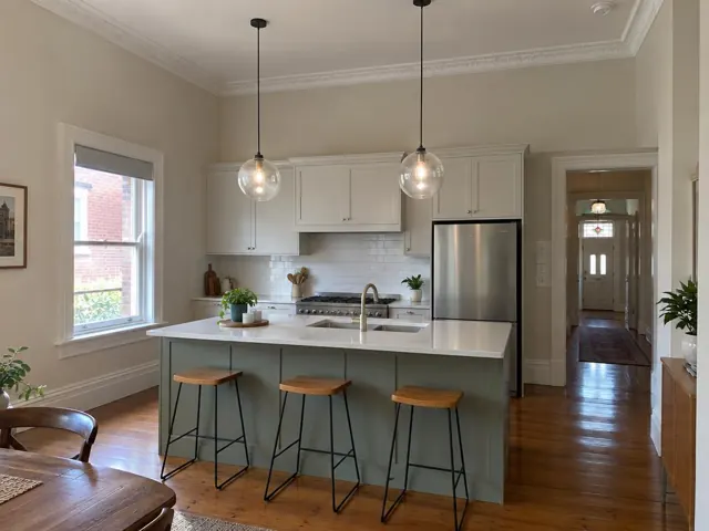 Two glass pendant lights over a kitchen island in a modern home interior in Hamilton